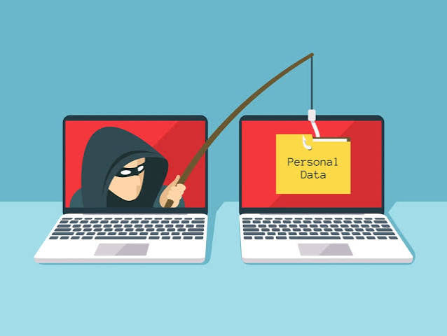 A masked figure phishing for personal data across two laptops